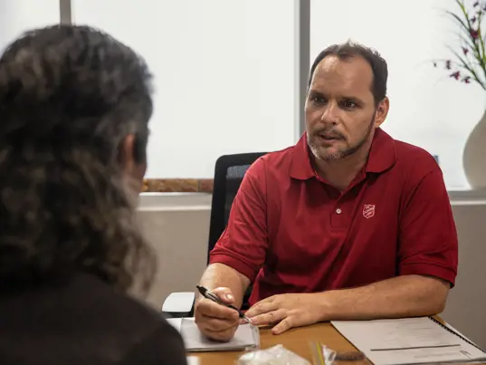Two people speaking in an office