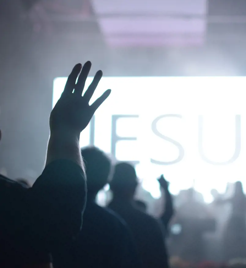 A crowd of people worshipping at church.