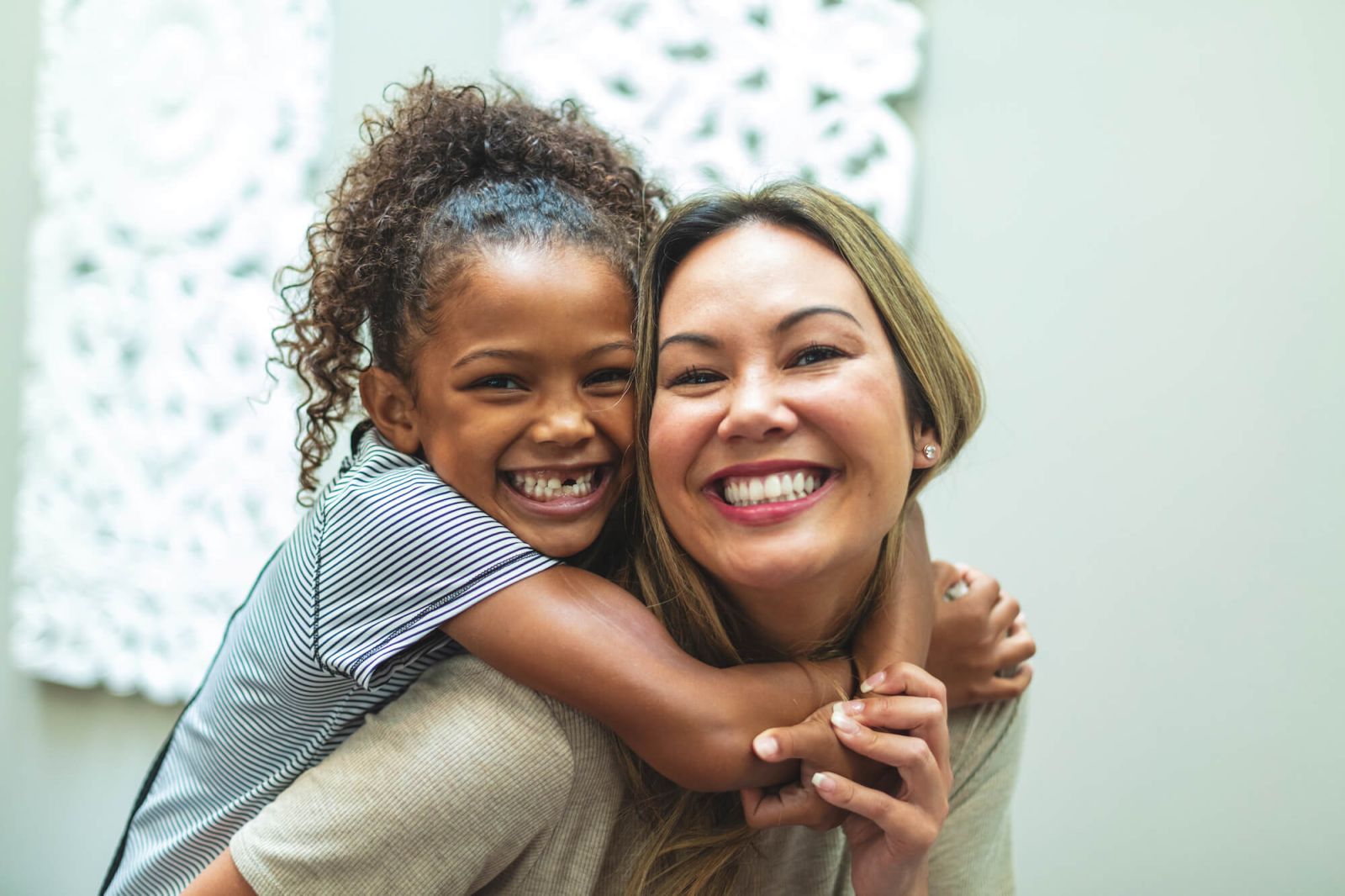 Mother and daughter smiling together.