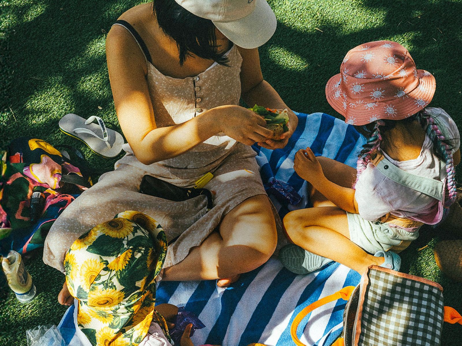 Mother and daughter sitting in a park