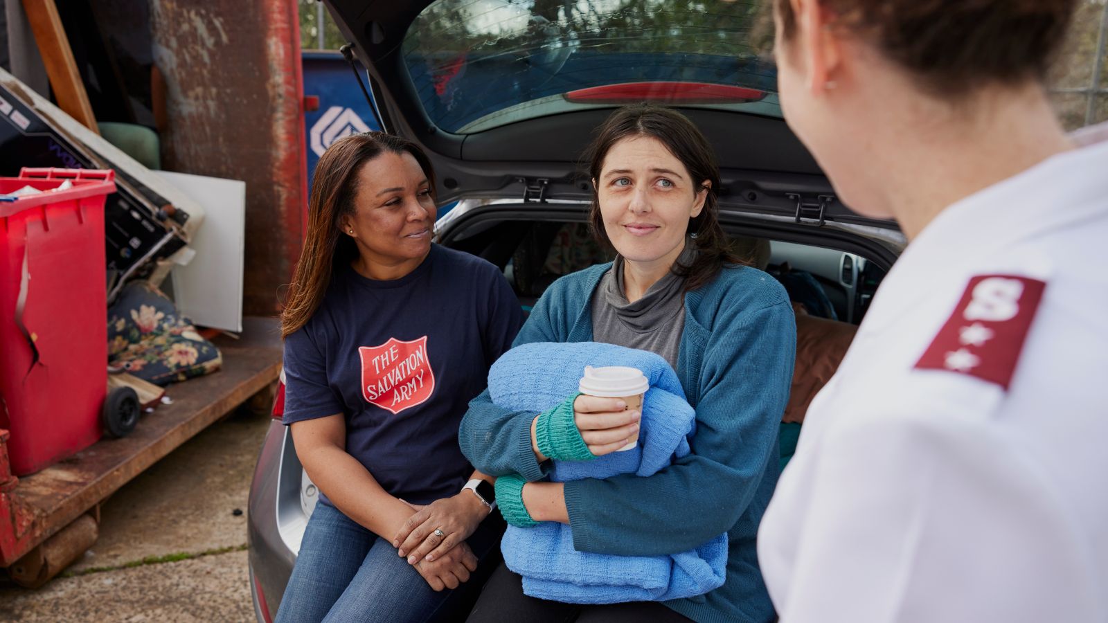 Red Shield Appeal Salvation Army Officer sitting with a woman