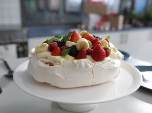 Pavlova Christmas dessert with strawberries, kiwi fruit and banana toppings. 