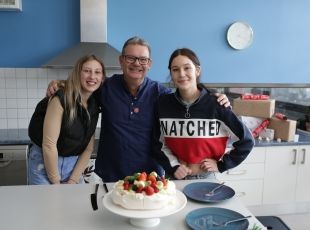 Celebrity chef Gary Mehigan standing with two female community members who were supported by the Salvos. 