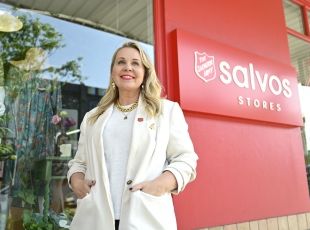 Sustainable stylist, Faye Delanty, standing outside of Salvos Stores. 