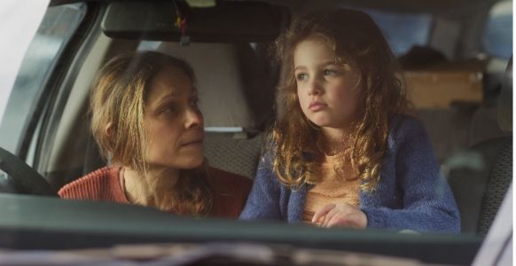 Sophie, a loving mother, is in a car with her daughter without a home. 