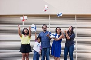 Reshmi's family throwing presents up into the air