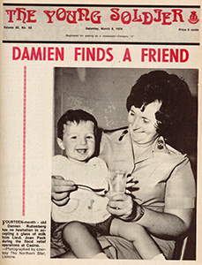 Lieut Joan Pack feeding Damien in flood relief 1974