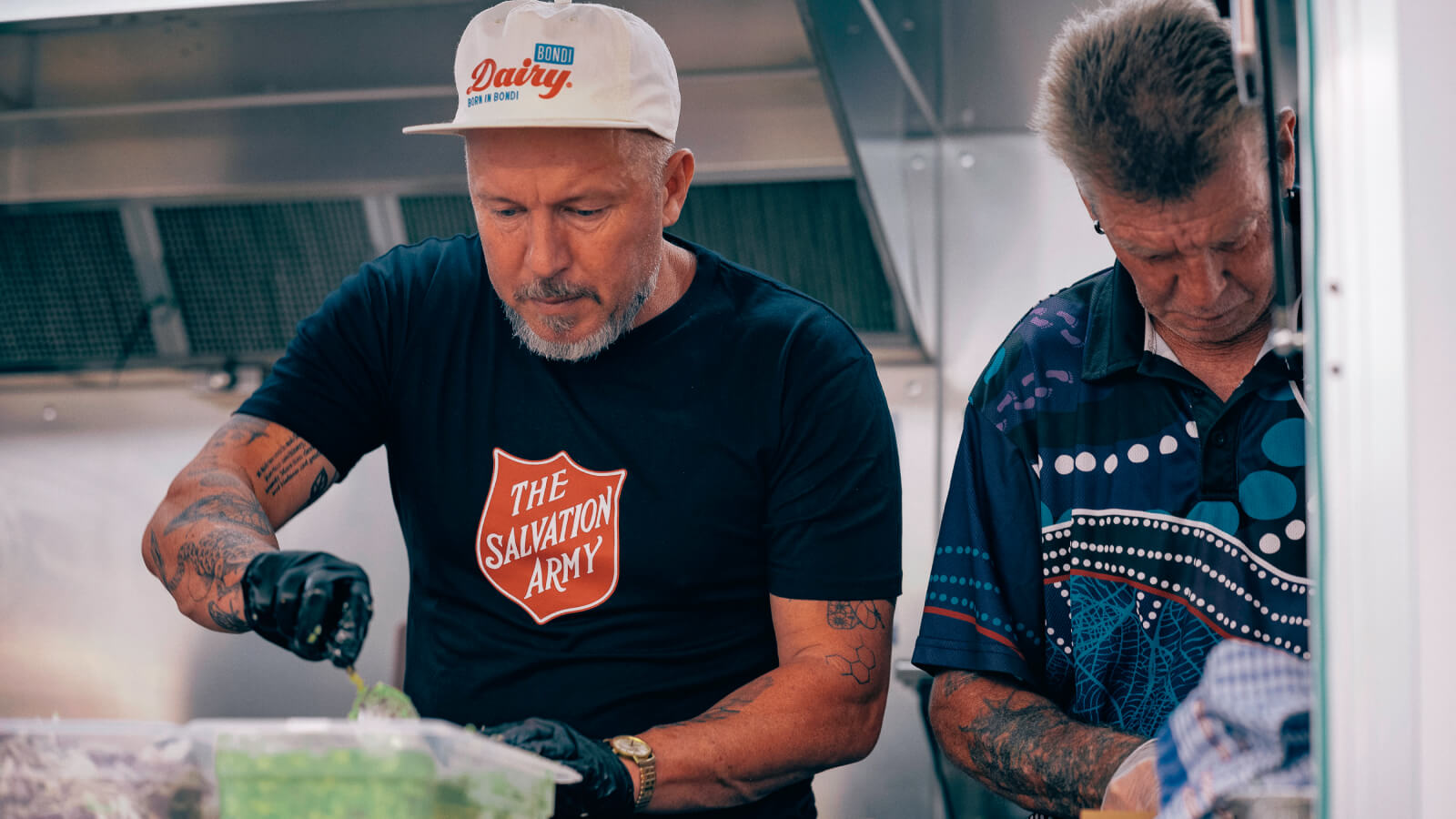 Chef Jason Roberts is happily lending a hand to serve food alongside some wonderful volunteers!