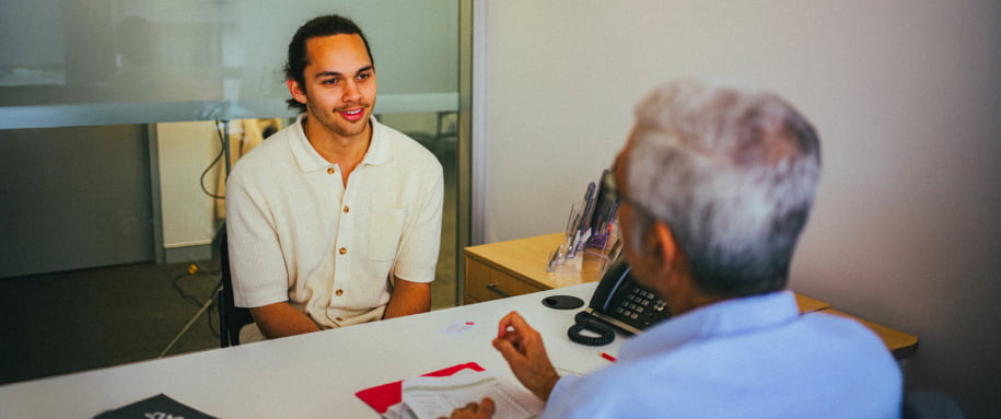 A young man discusses his financial plans with a Moneycare expert