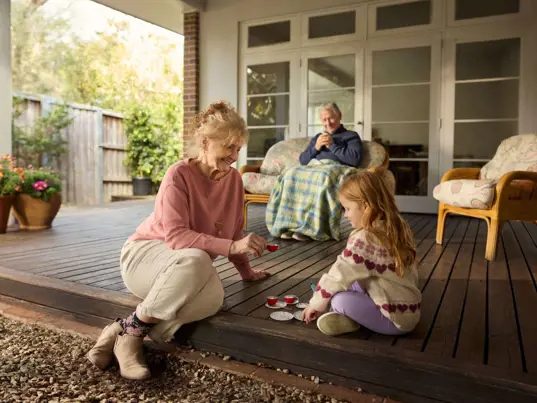 Two grandparents spend some time with their young granddaughter.